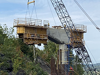 Crane and machines hold abutment one during formation